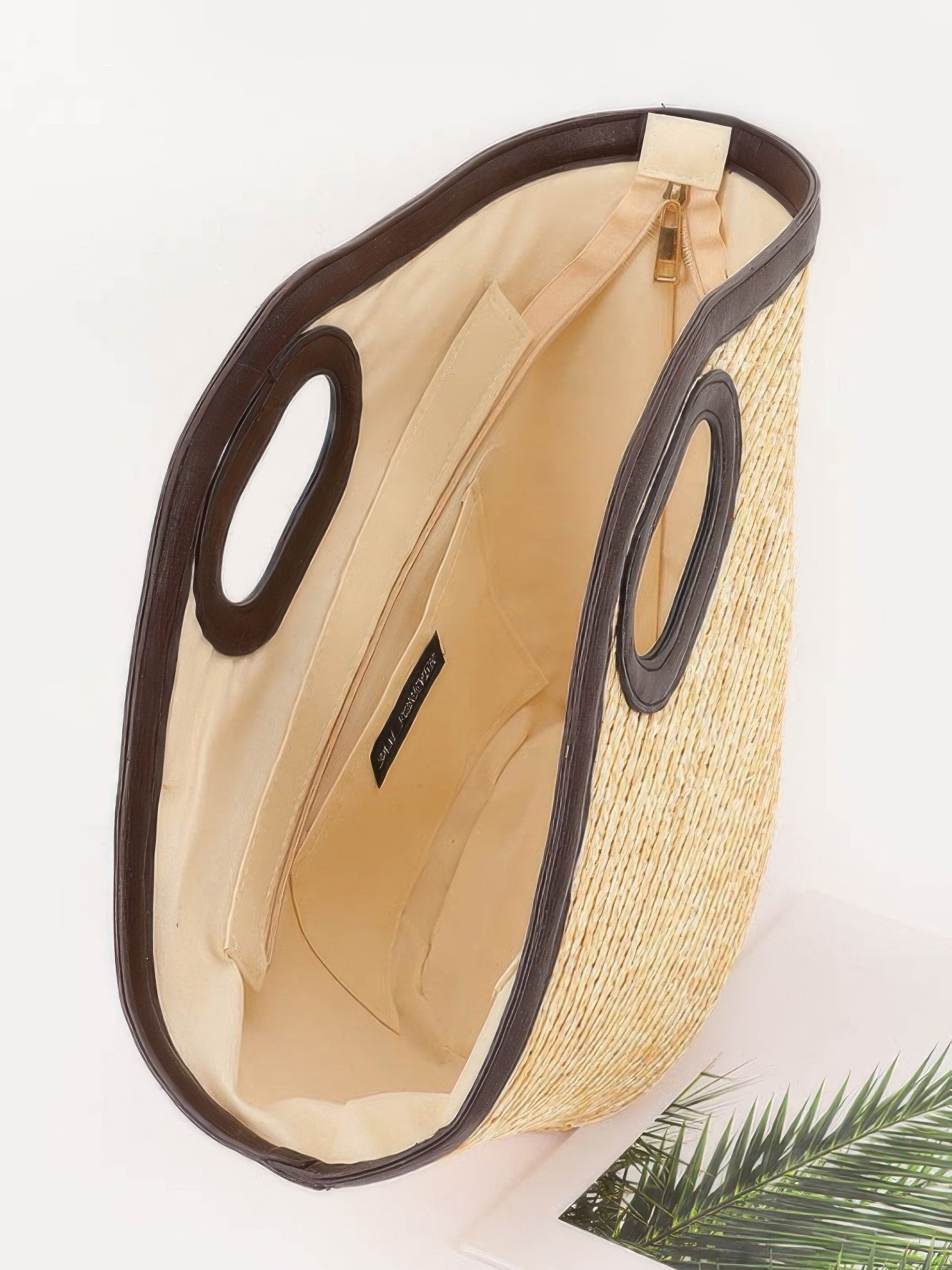 Interior view of a Straw Beach Bag showing its spacious design and sturdy handles.