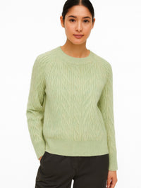The Maple Braided Cable Sweater in light green, front view