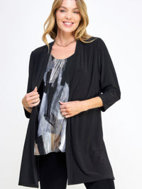 Model wearing the Hit Duster Jacket over a patterned top, showcasing its relaxed and polished style.