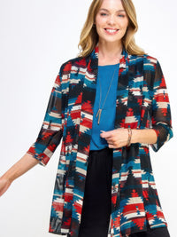 Woman wearing a colorful Mr Princess Jacket over a blue top and black pants, showcasing a stylish and versatile look.