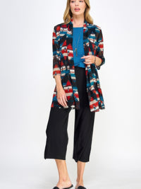 Model wearing Mr Princess Jacket with a colorful pattern, paired with a blue top and black pants, showcasing versatile fashion.