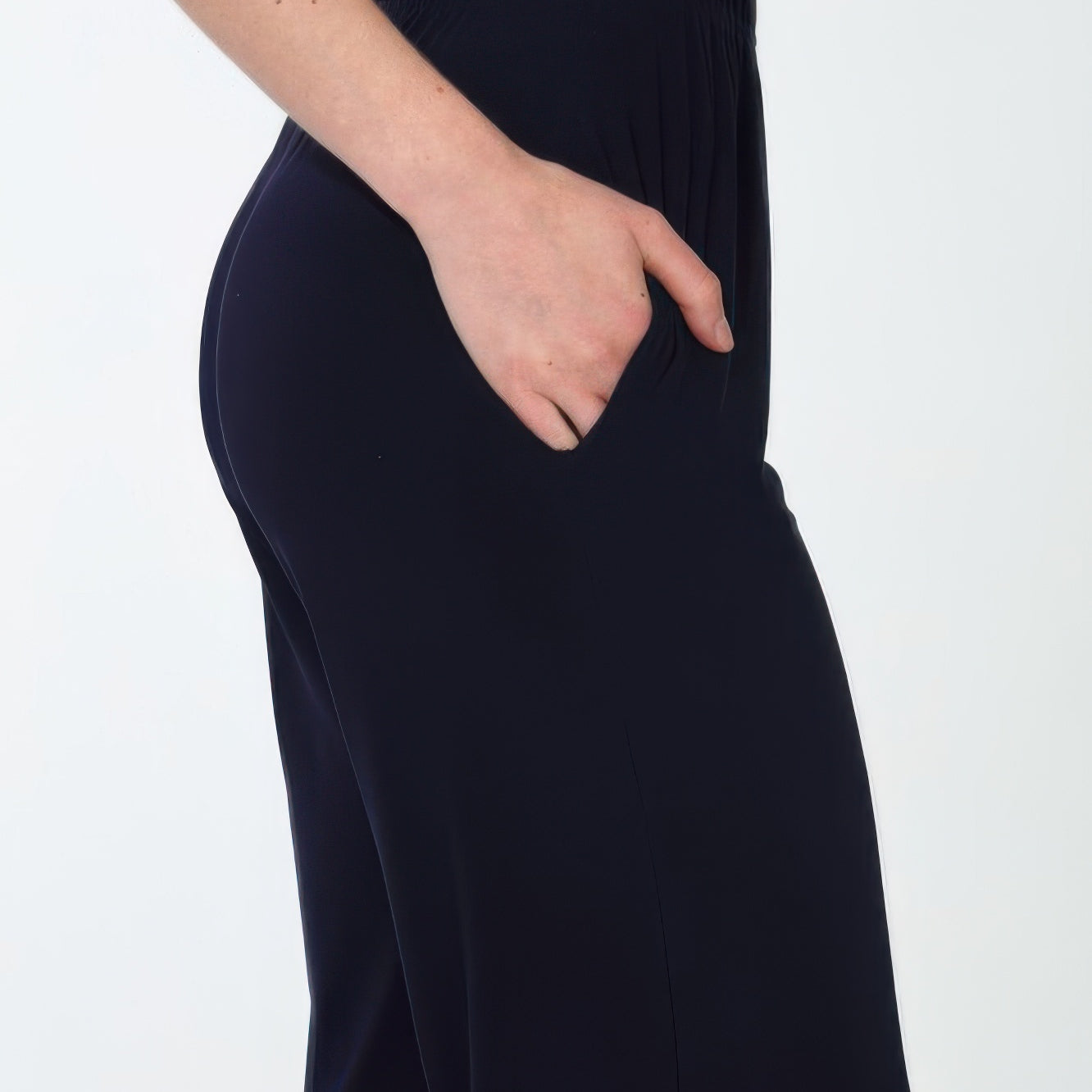 Side view of Hit Wide Leg Ankle Length Pants with pockets and an elastic waistband, showcasing a relaxed fit.