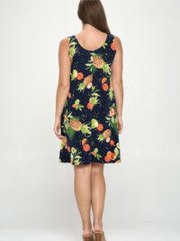 Back view of a woman wearing a Plus Size BNS Print Missy Tank Dress with vibrant fruit prints on a navy background.