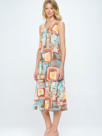 Short Sleeve And Soft Round-Neckline Long Dress featuring colorful abstract print on a model standing.
