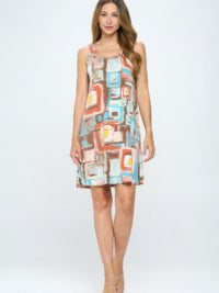 BNS Print Missy Tank Dress modeled by a woman, featuring colorful geometric patterns and a sleeveless design.