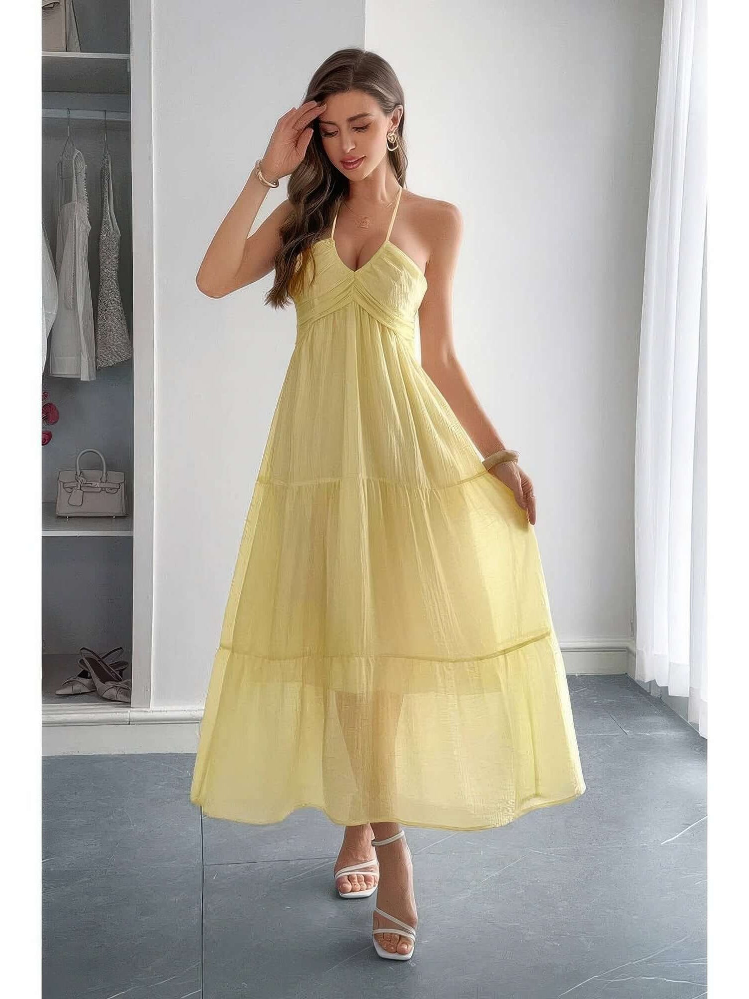 Solid Halter Muse Tiered Ruffle Long Dress in soft yellow, featuring graceful ruffles and a flattering halter neckline.