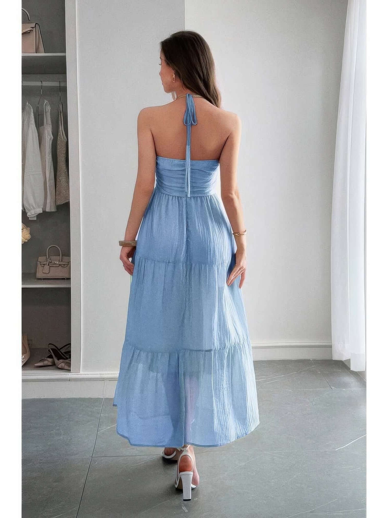 Solid Halter Muse Tiered Ruffle Long Dress shown from the back in light blue, highlighting ruffled layers and halter neckline.