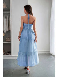 Solid Halter Muse Tiered Ruffle Long Dress shown from the back in light blue, highlighting ruffled layers and halter neckline.