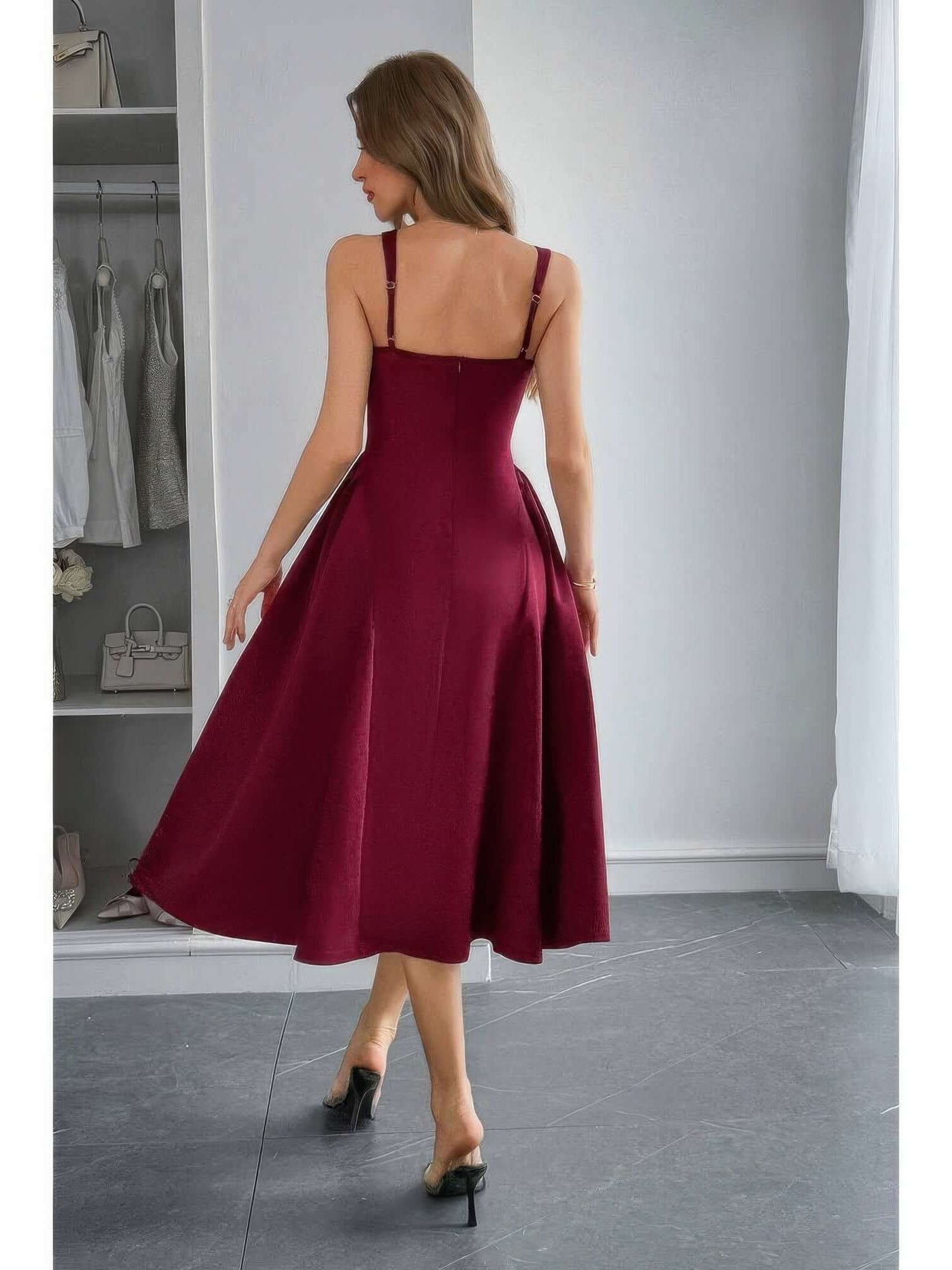 Back view of a model wearing the Square Neck A Line Pleated Sleeveless Long Dress in burgundy, showcasing its elegant flow.