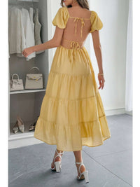 Solid Backless Tiered Puff Sleeve Fit Midi Dress in yellow, showcasing back view with puff sleeves and tiered skirt.