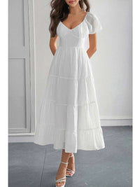 Solid Backless Tiered Puff Sleeve Fit Midi Dress worn by a model, showcasing the elegant backless design and puff sleeves.