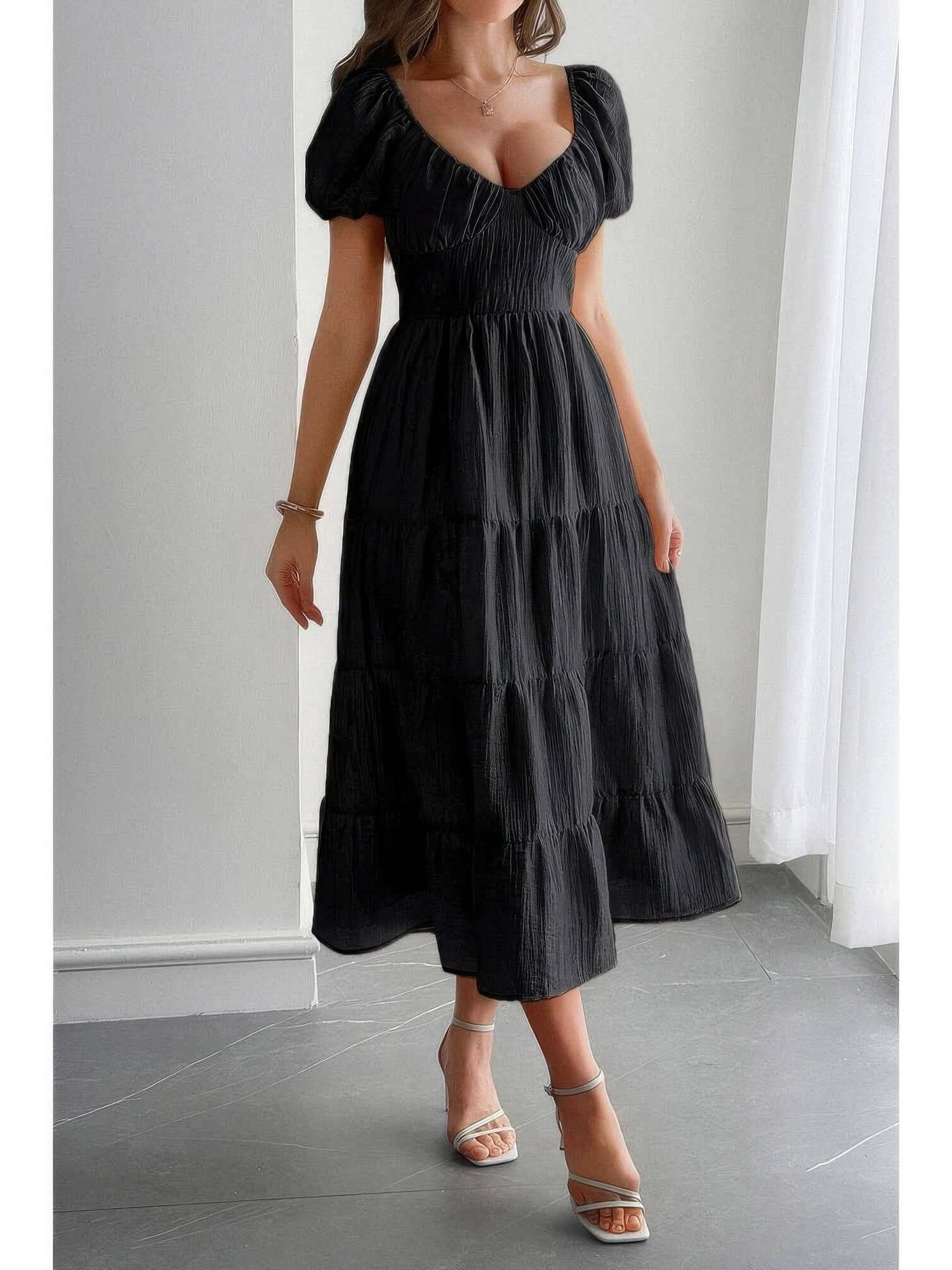 Solid Backless Tiered Puff Sleeve Fit Midi Dress modeled by a woman in a black tiered puff sleeve midi dress.