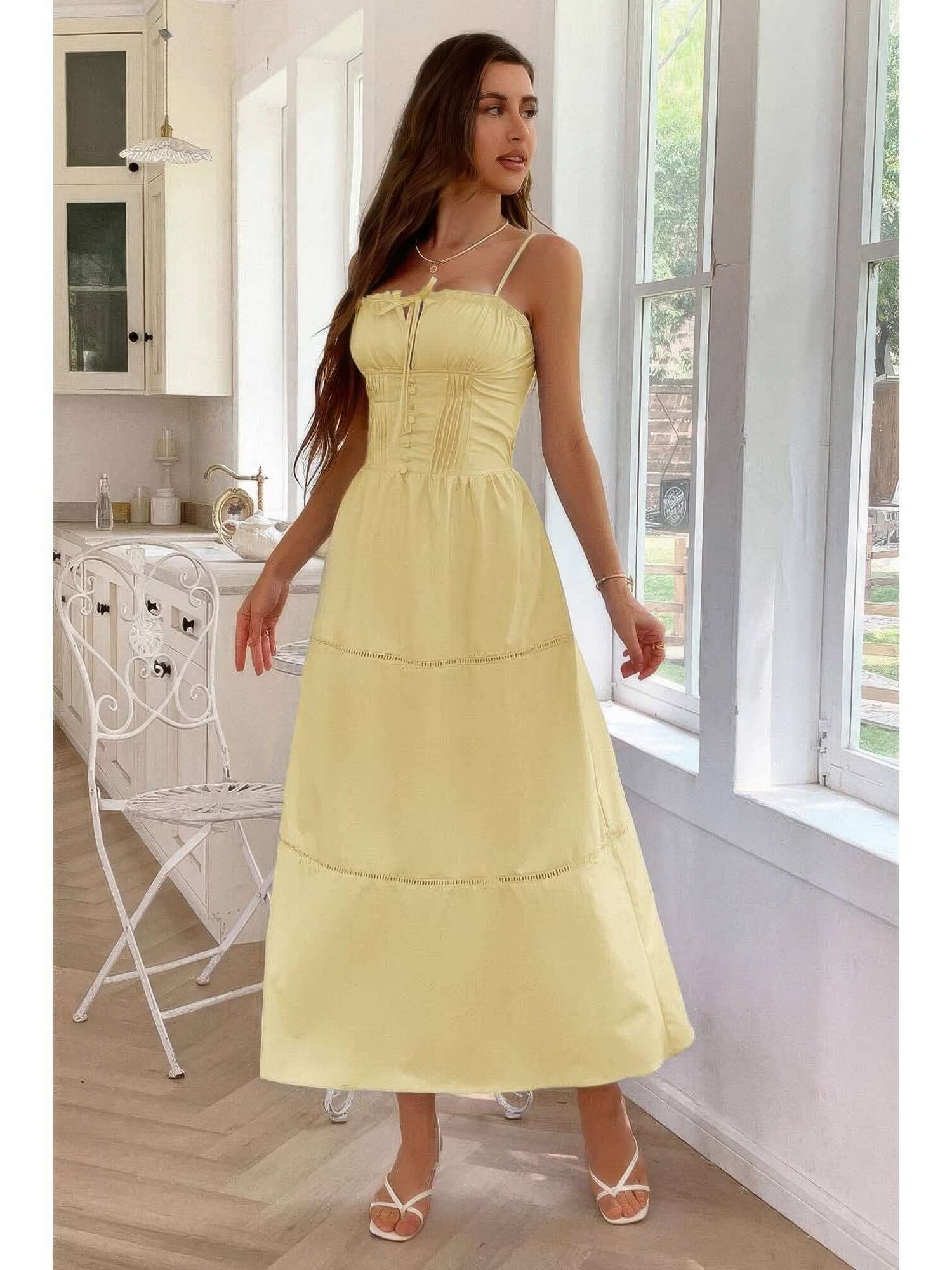 A model wearing a Solid Button Decor Pintuck Eyelet Shirred Dress in yellow, showcasing its feminine style and charm.