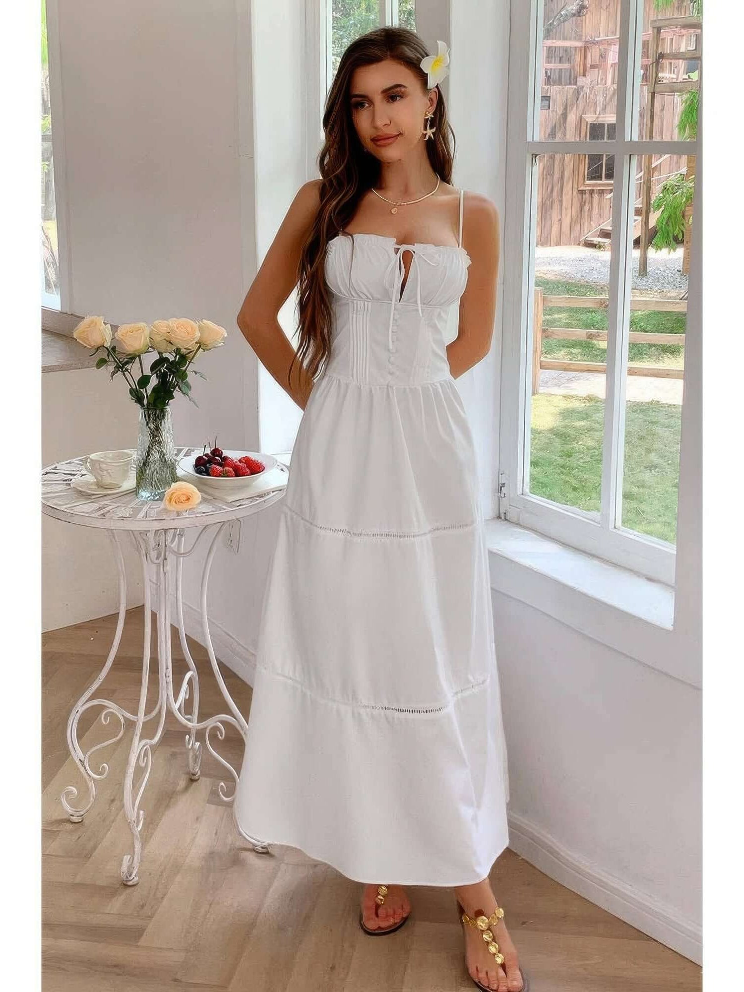 Solid Button Decor Pintuck Eyelet Shirred Dress worn by a model in a bright room with a floral backdrop.