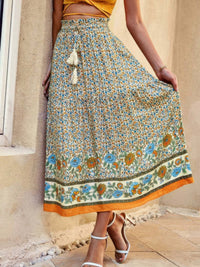 Drawstring Floral Ruffled Maxi Skirt featuring a vibrant pattern and ruffle details, styled for sunny outings.