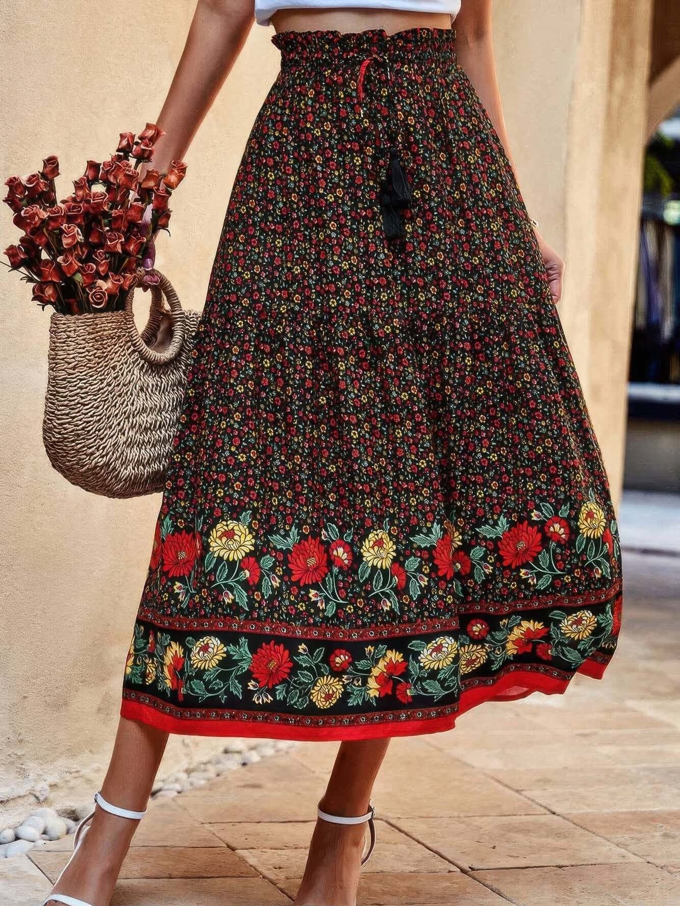 Drawstring Floral Ruffled Maxi Skirt in black floral print, featuring ruffles and a drawstring waist, styled with a woven bag.