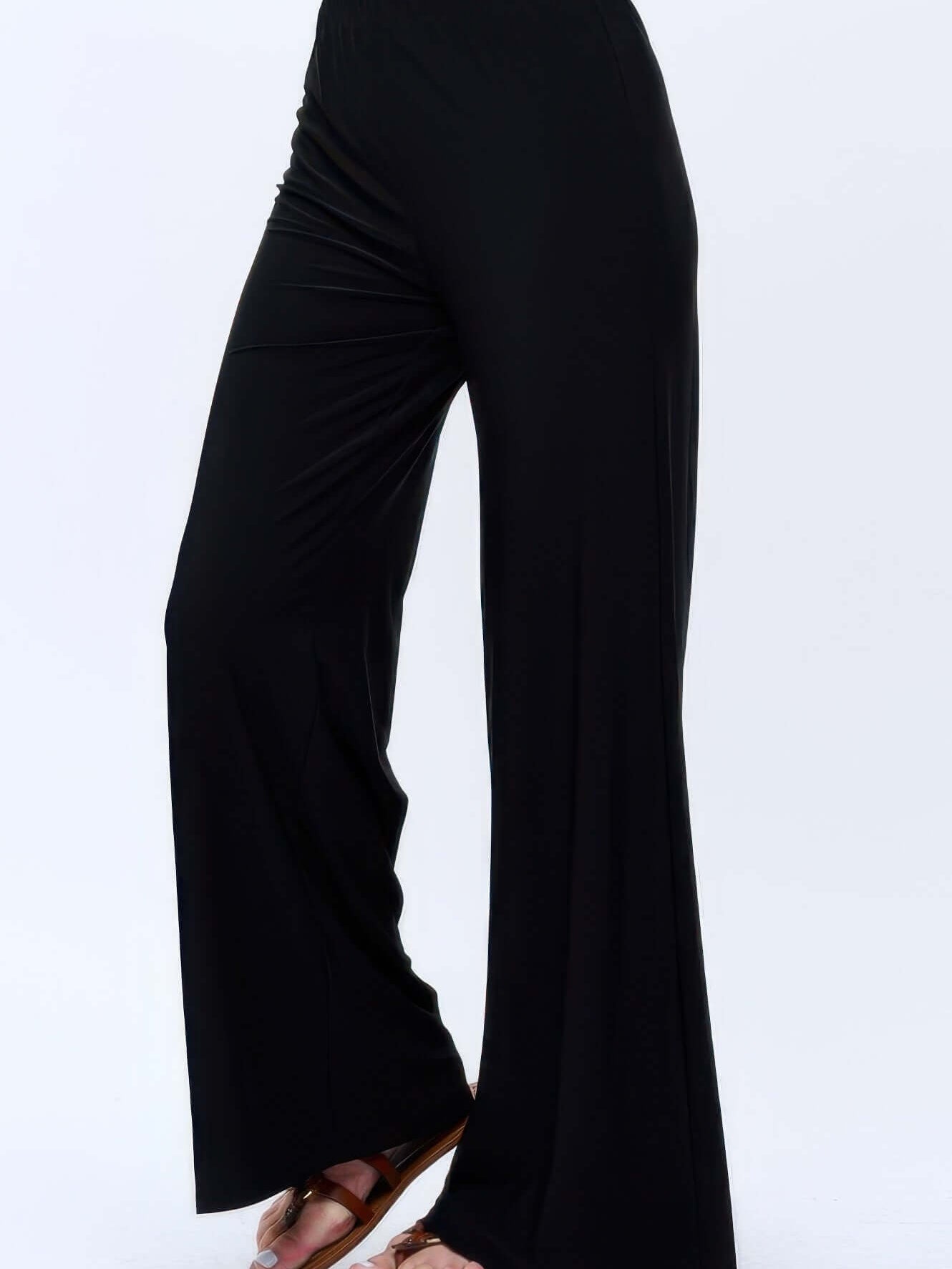 Hit Palazzo Pants shown in black with wide legs and an elastic waistband, perfect for warm days.