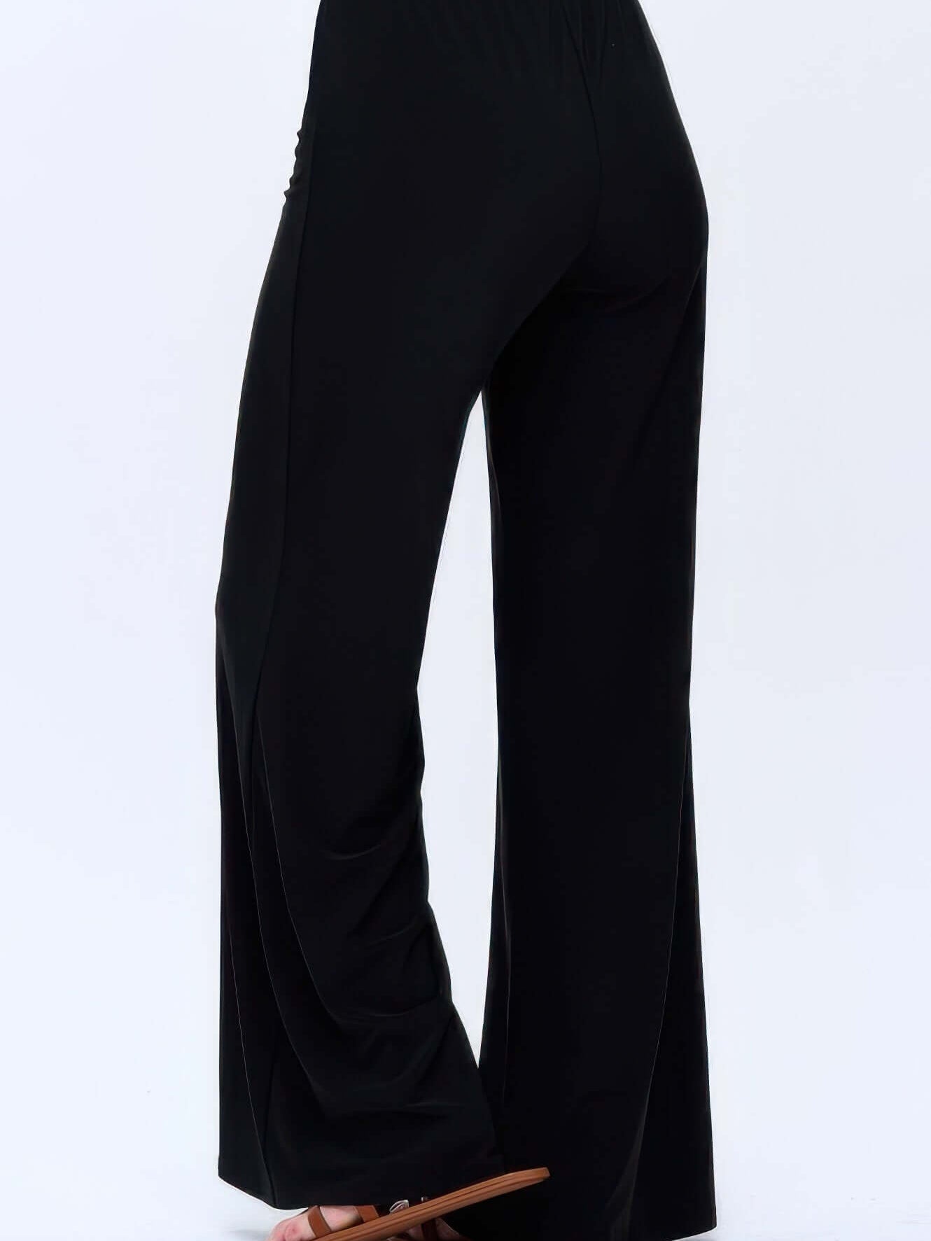 Women wearing black Hit Palazzo Pants with a wide leg and elastic waistband, showcasing comfort and style.
