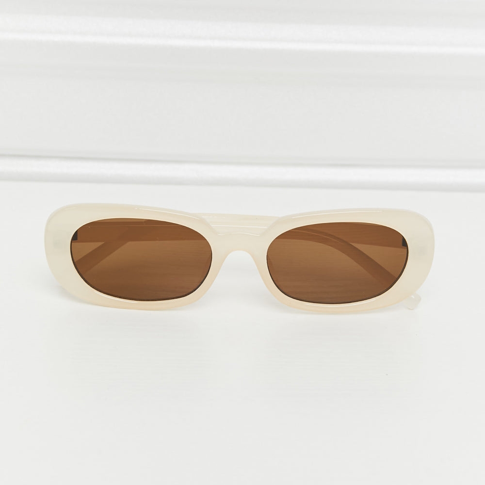 Oval Full Rim Sunglasses in cream with brown lenses, featuring a sleek polycarbonate design.