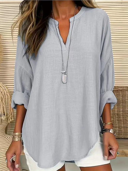 Solid Color Notched Long Sleeve Blouse in light gray worn by a woman, showcasing its relaxed fit and chic style.