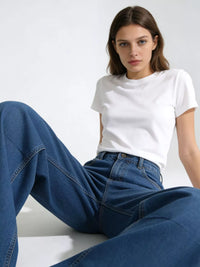 Model wearing Wide Leg Washed Jeans and a white t-shirt, showcasing relaxed fit and style.