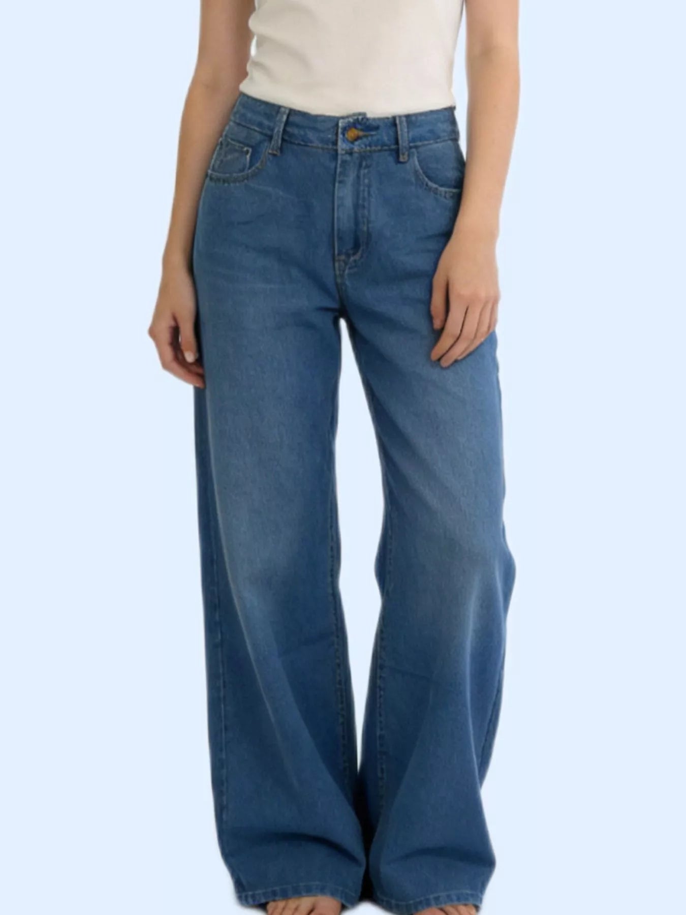 Model wearing Wide Leg Washed Jeans with a fitted top, showcasing pocketed design and relaxed fit.