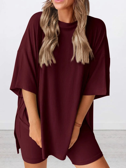 Full Size Oversized Slit Round Neck Top and Shorts Lounge Set Plus Size in burgundy color on model.