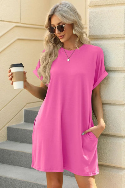 Florira Short Sleeve Mini Dress with Pockets in vibrant pink, styled with oversized sunglasses and a coffee cup.