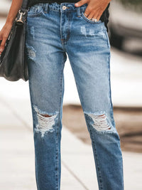 Distressed Wash Ankle Jeans in blue with ripped details and raw hem, perfect for casual outfits.