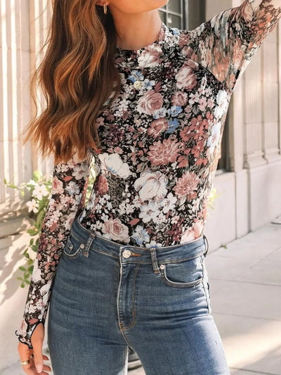 Lovelet Mock Neck Long Sleeve Top modeled with floral design and paired with jeans in a stylish outdoor setting.