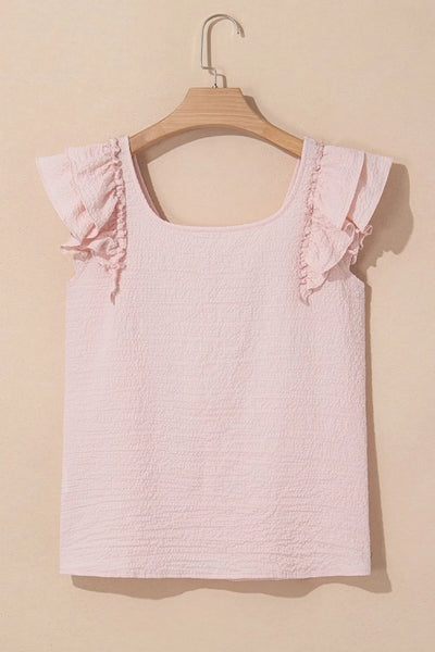 Textured Bow Knot Frilled Butterfly Sleeve Blouse in soft pink color with ruffled sleeves on a wooden hanger.