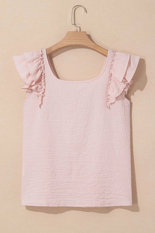 Textured Bow Knot Frilled Butterfly Sleeve Blouse in soft pink color with ruffled sleeves on a wooden hanger.