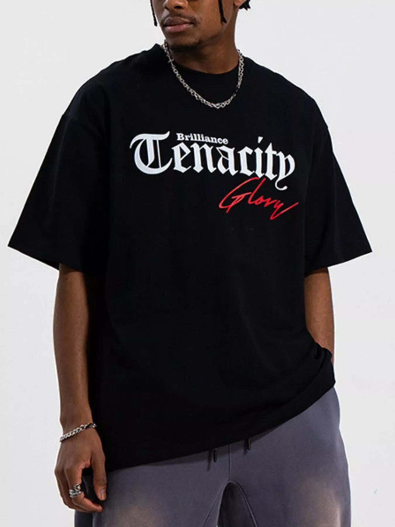 Men's TENACITY Round Neck Short Sleeve T-Shirt in black with 'Brilliance' and 'Glory' graphic design.