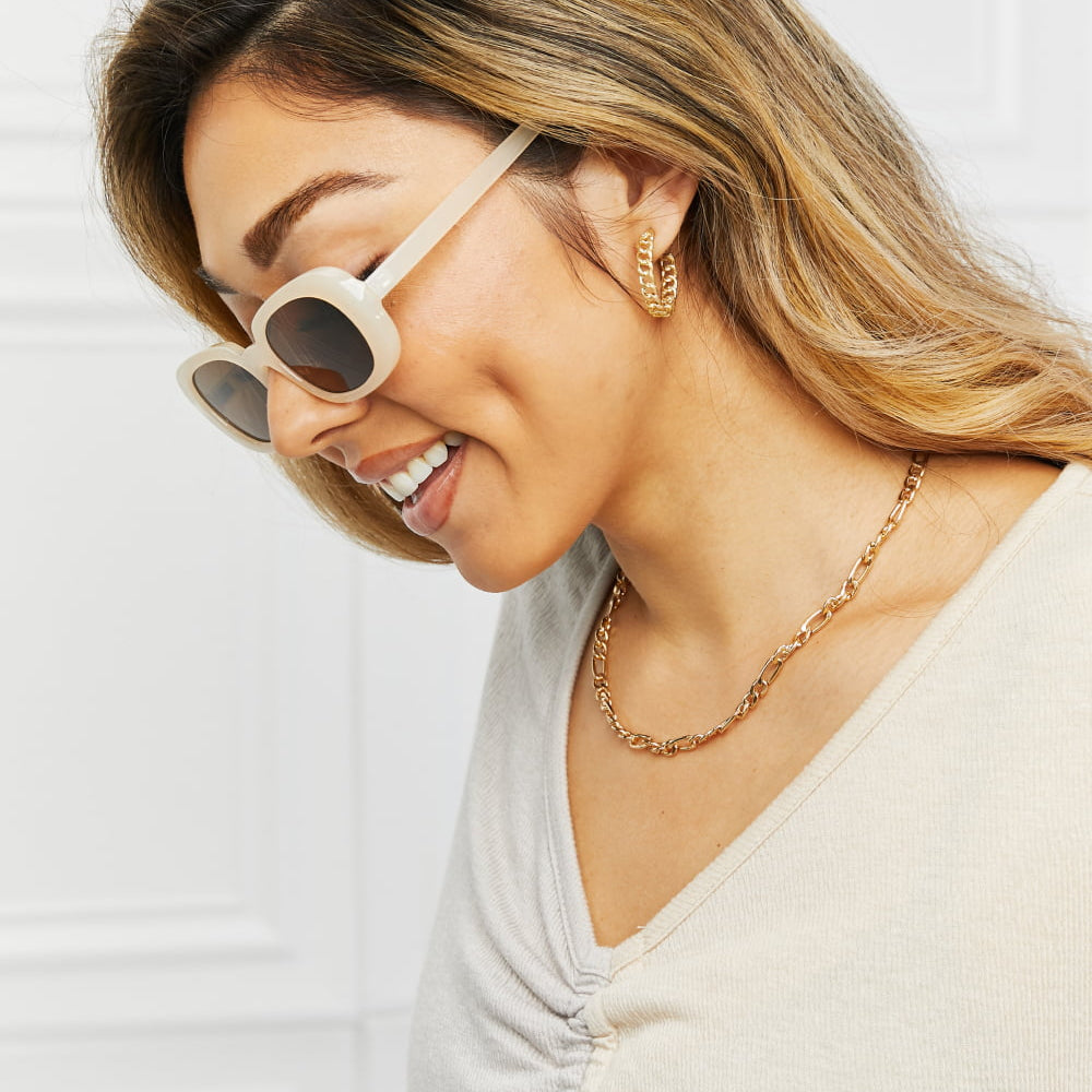 Oval Full Rim Sunglasses worn by a woman, showcasing trendy eyewear style and accessories.