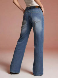 Model showcasing the back view of Vintage Wash Wide Leg Jeans with a relaxed fit and pocket detail.