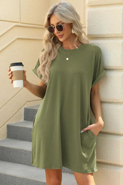 Florira Short Sleeve Mini Dress with Pockets in olive green worn by a woman holding a coffee cup.