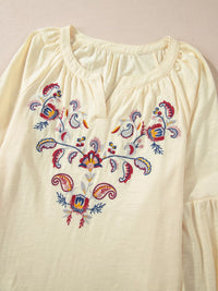 Embroidered Notched Balloon Sleeve Blouse featuring intricate floral embroidery and a soft fabric texture.