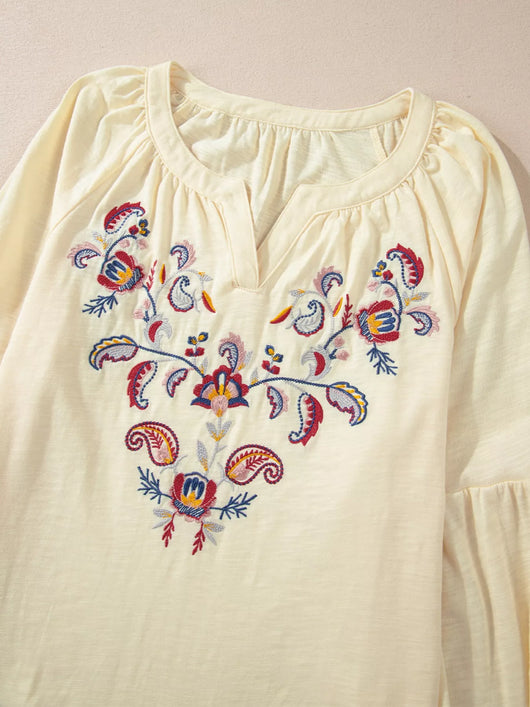 Embroidered Notched Balloon Sleeve Blouse featuring intricate floral embroidery and a soft fabric texture.