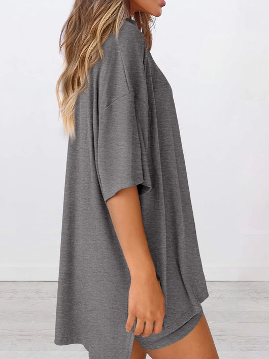Full Size Oversized Slit Round Neck Top and Shorts Lounge Set Plus Size in grey, showcasing its relaxed fit and style.