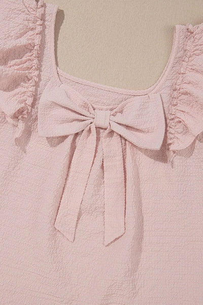 Textured Bow Knot Frilled Butterfly Sleeve Blouse detailing the pink bow and ruffled sleeves.