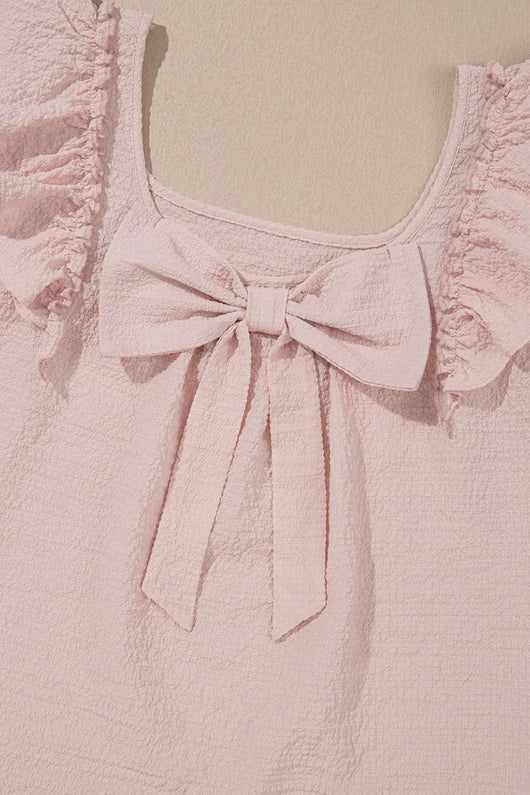 Textured Bow Knot Frilled Butterfly Sleeve Blouse detailing the pink bow and ruffled sleeves.